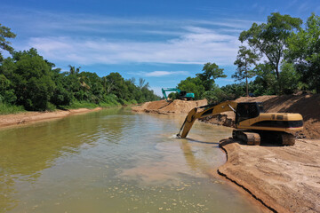 Wall Mural - Environmental conservation issue. Machinery mining river, causing siltation and pollution 