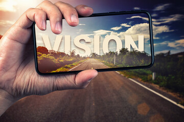 Wall Mural - Vision behind the tree through mobile phone on empty asphalt road at golden sunset and beautiful blue sky. Concept for new vision.