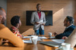 © JonoErasmus - Manager going over paperwork with staff during a boardroom meeting