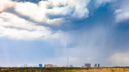 Poster - panoramic view of rain and rainy clouds over city and park in spring