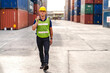 © Art_Photo - Professional engineer container cargo foreman in helmets working standing and using walkie talkie checking stock into container for loading.logistic and business export