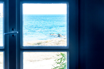  A window with a view of the sea in Greece