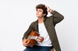 © luismolinero - Young caucasian man with guitar over isolated white background having doubts and with confuse face expression
