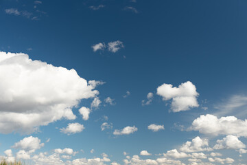 white cumulus clouds on a blue sky. Place for text