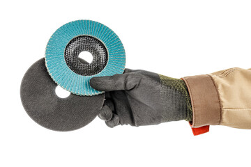 Wall Mural - Worker hand in black protective glove and brown uniform holding abrasive flap disc and cutting abrasive disc for angle grinder isolated on white background