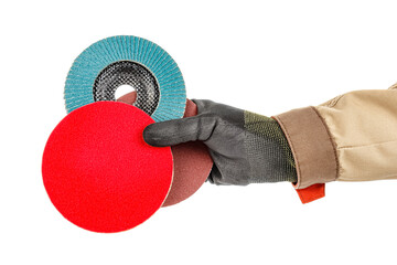 Wall Mural - Bright red polishing disc with blue abrasive flap disc and sanding paper disc in worker hand in black protective glove and brown uniform isolated on white background