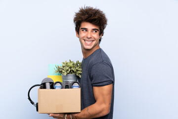 Man making a move while picking up a box full of things laughing