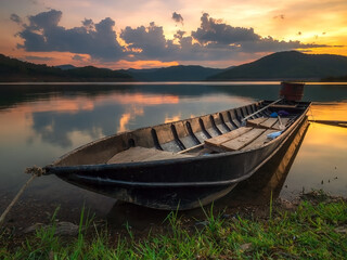 Naklejka na meble The  longtail boat park on the lake  at sunset time.