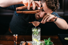 Expert Bartender And Barman Pouring And Preparing Mojito Cocktails