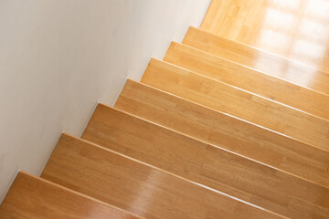 Poster - wooden stair step with white wall background.