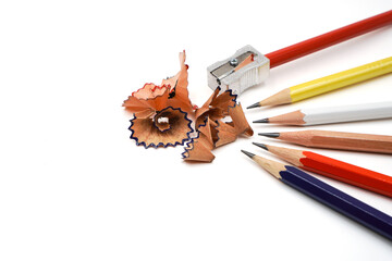 Wooden color pencils with sharpener on white background represent concept of sharpen up to develop or improve ourself to become better , smarter ,more skillful in business performance and education