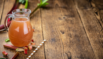 Wall Mural - Rhubarb Juice on rustic background (close up; selective focus)