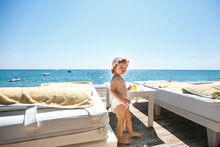 Little Girl In A Diaper On The Sea In A VIP Bungalow. Family Holidays With Children At The Sea