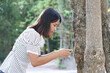 © buraratn - Asian women use smartphones to take pictures of trees, the concept of love for the world.