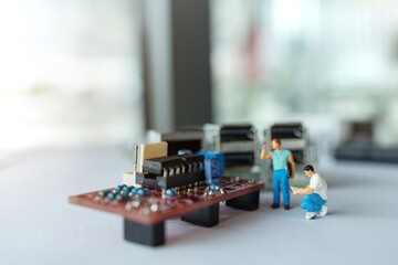 miniature people : engineer checking and fixed mainboard : engineering concepts