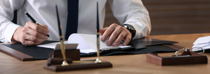 Wall Mural - Male notary working at table in office, closeup. Banner design