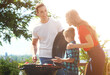 © New Africa - Happy family having barbecue with modern grill outdoors on sunny day