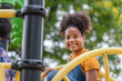 African American girl smiling look at camera at playground in the park