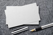 © Kuzmick - Mockup of business card with fountain pen at black slate background