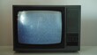 Old retro CRT television TV set with static noise snowing on screen