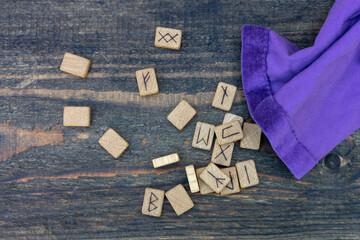 Wall Mural - Scandinavian wooden runes on an old wooden table. Elder Futhark.