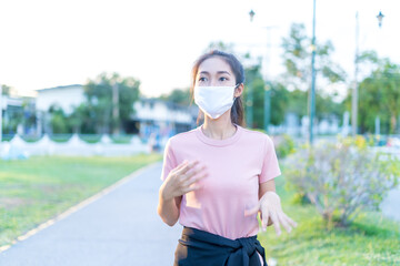 Young women wearing hygiene masks in public parks, Covid 19