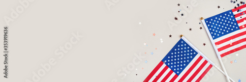 Festive background with US flags and confetti in the shape of stars. US independence day.