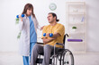 © Elnur - Young male patient in wheel-chair doing physical exercises