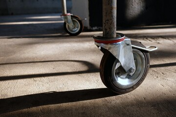 Wheel of Scaffolding with Shadow on Concrete Ground.