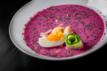 Poster - Vegetable cold soup with beet, cucumber, radsih and egg on black wooden table