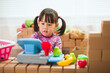 © M-image - toddler girl pretend play shop keeper at home