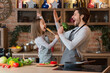 © Prostock-studio - Little girl and her dad having fun in kitchen while cooking together