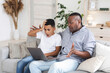 © Prostock-studio - African boy and his grandfather looking at laptop screen with shock