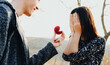 © Strelciuc - Surprised caucasian girl asked to get married by her lover in a field is covering her face with palms in front of the wedding ring