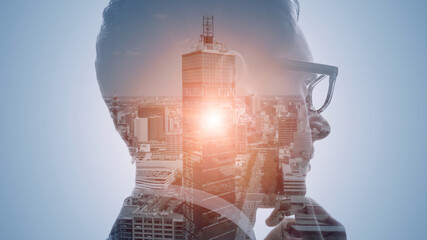 Double exposure of a businessperson and cityscape.