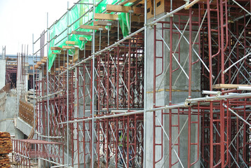 Wall Mural - JOHOR, MALAYSIA -JUNE 30, 2016: Scaffolding used as the temporary structure to support platform, form work and structure at the construction site. Also used it as a walking platform for workers. 

