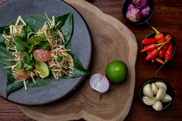 Wall Mural - Indonesian cuisine- Balinese spicy mango salad with vegetables, sprouts, grapefruit or pomelo, mint leaves and chili.