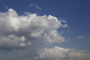 Wall Mural - white fluffy clouds in the blue sky.
