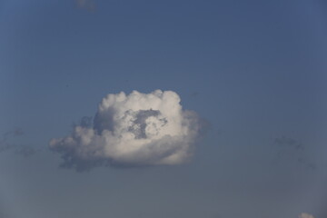 Wall Mural - white fluffy clouds in the blue sky.