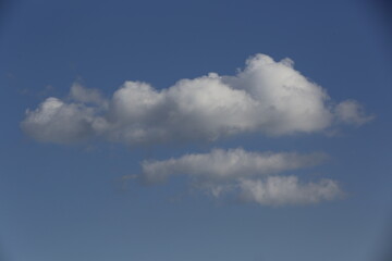 Wall Mural - white fluffy clouds in the blue sky.