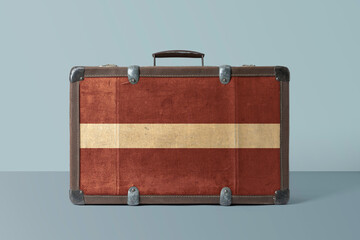 Wall Mural - Latvia flag on old vintage leather suitcase with national concept. Retro brown luggage with copy space text.