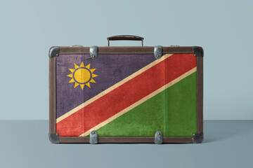 Wall Mural - Namibia flag on old vintage leather suitcase with national concept. Retro brown luggage with copy space text.