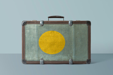 Wall Mural - Palau flag on old vintage leather suitcase with national concept. Retro brown luggage with copy space text.