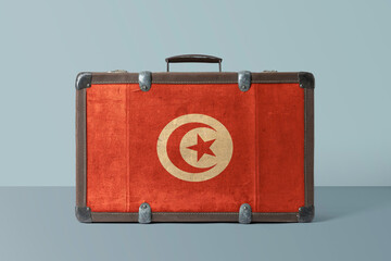 Wall Mural - Tunisia flag on old vintage leather suitcase with national concept. Retro brown luggage with copy space text.