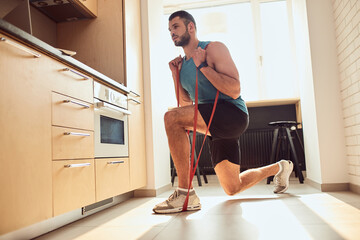 Poster - Athletic gentleman doing exercise with elastic fitness band