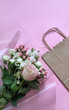 © NataliAlba - delivery service packing bag flovers pink white background gift shipping