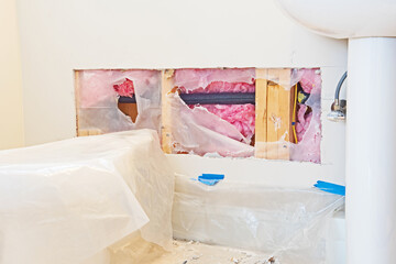 a hole in the drywall has been prepared so that it can be patched with a new piece.