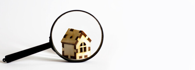 Magnifying glass with wood house model on white background, Home inspection concept.