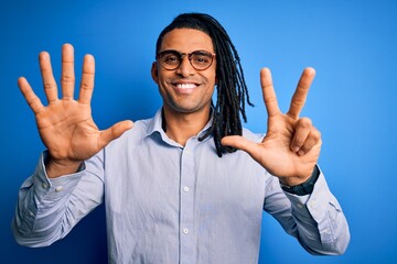 Young handsome african american man with dreadlocks wearing casual shirt and glasses showing and pointing up with fingers number eight while smiling confident and happy.