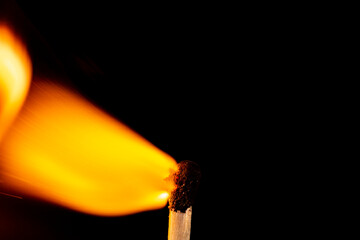 Burning match isolated on black background. Macro. Close up. Fire.